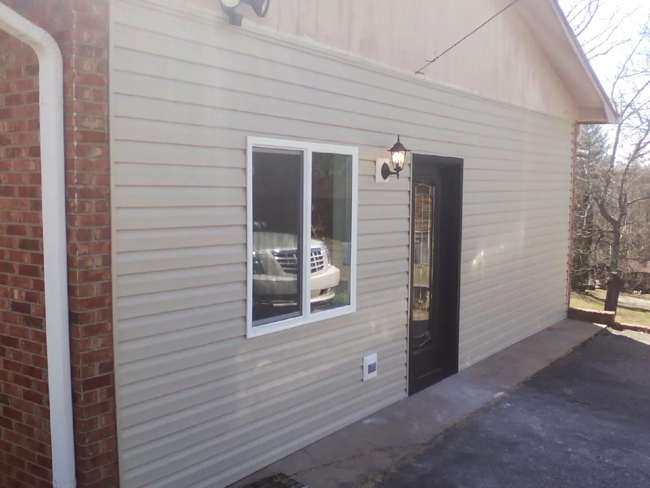 New vinyl siding and entry door on a room addition in Moundsville