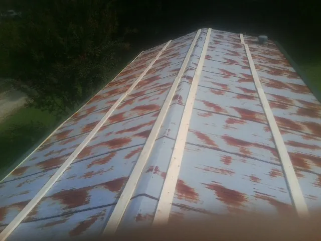 Rusted metal roof panels with new wood purlins before replacement — Storm Damage Roof Repair in Moundsville by Roofing Brothers